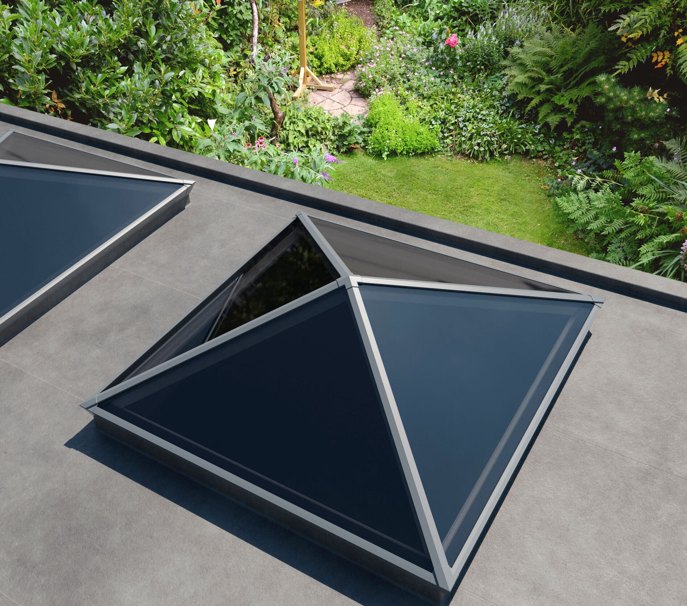 Photo outside above pyramid style roof lantern overlooking garden